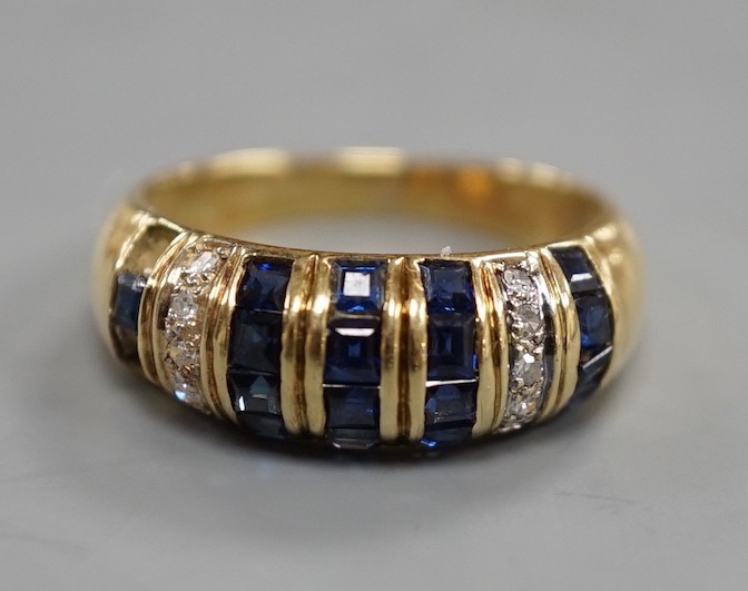 A modern yellow metal, sapphire chip and diamond chip set half hoop cluster ring, size M/N, ross weight 3.6 grams(two sapphires missing).